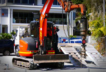 Medium size excavator with a Digga Drive unit for installing piles using a Torque Hub.
