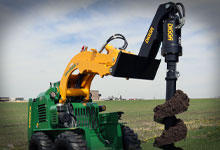 Compact loader with Digga attachments, featuring a Boom Extension, Auger, and Auger Bit.