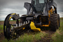 Skid steer loader mounted with a Digga Bigfoot Trencher for digging trenches.